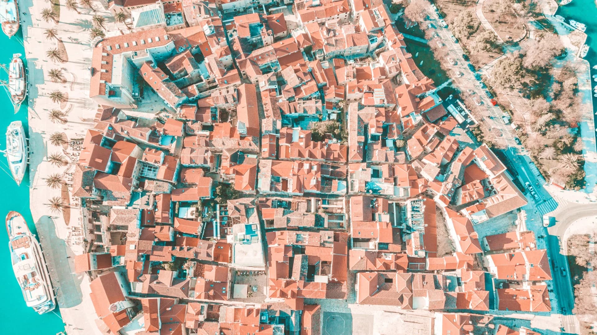 Straight down over Trogir's terracotta roofs and the palm-lined riva — Blue Lagoon & Trogir — Half Day