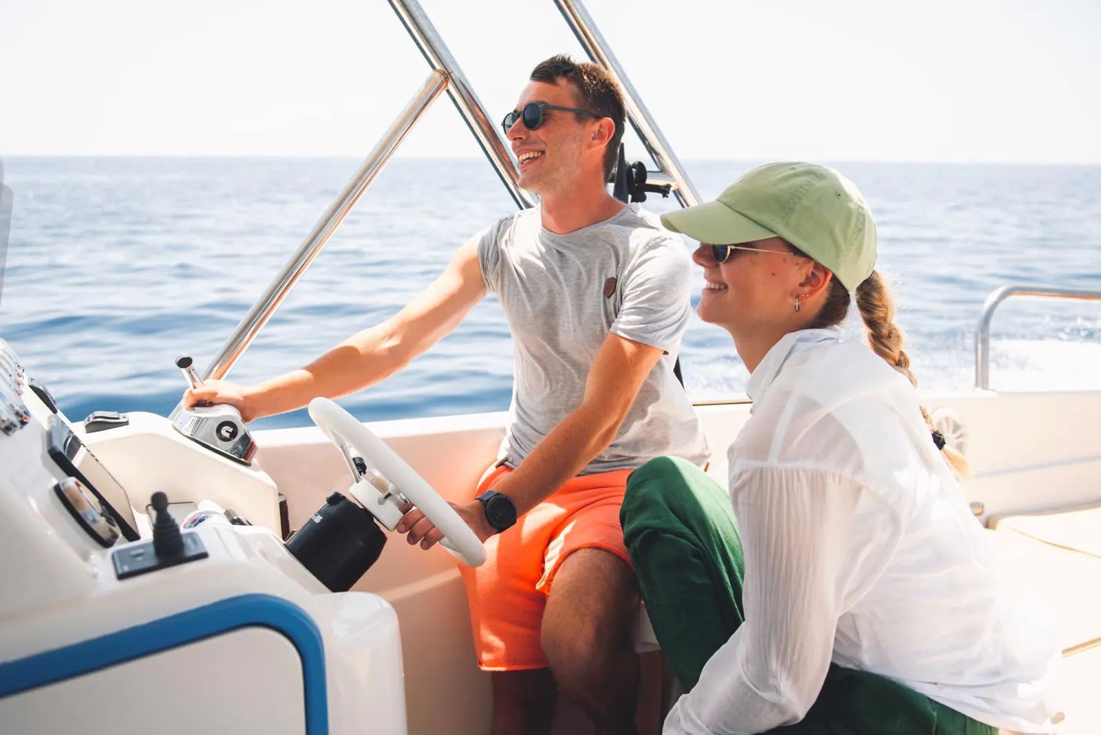Two of the crew at the helm of the speedboat — Blue Cave Tours