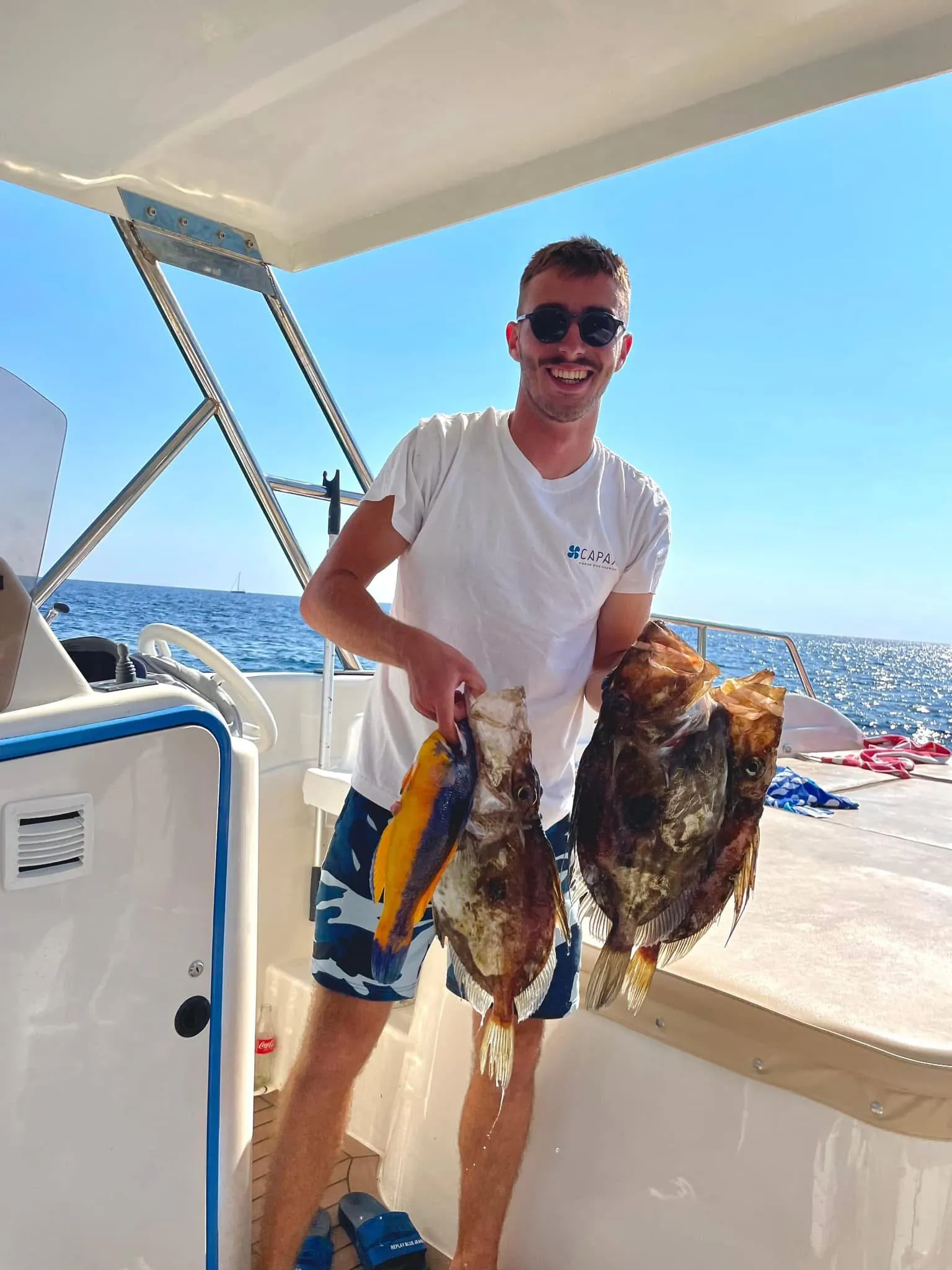 A member of the crew on deck with the day's catch — Blue Cave Tours